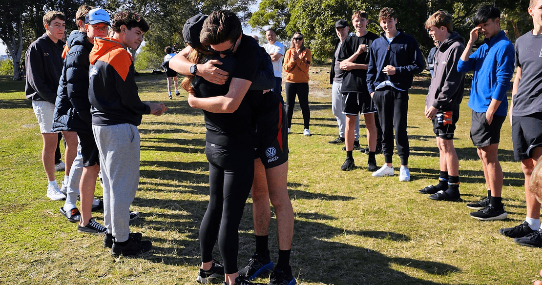 Bailey embraces his mum as he crosses the finish line.